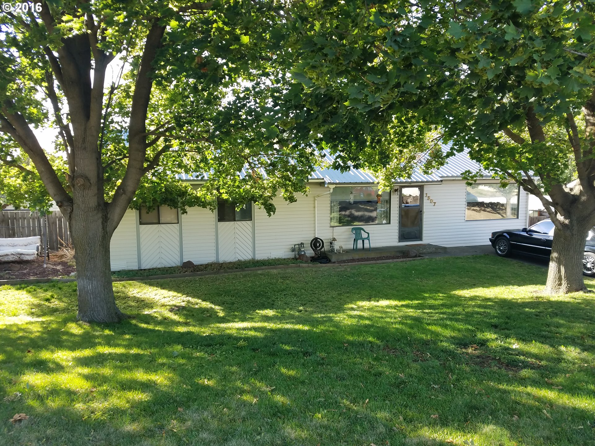 1807 Southwest Goodwin Place Pendleton, OR 97801 - Photo 1 of 24 a view of a house with a backyard and a tree