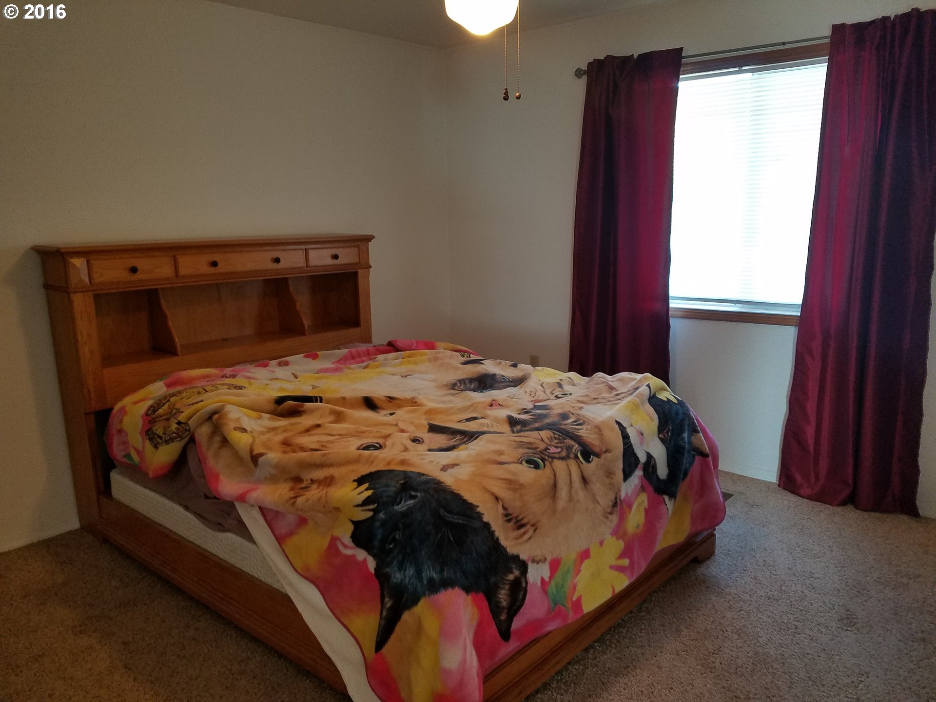 1807 Southwest Goodwin Place Pendleton, OR 97801 - Photo 16 of 24 a bed sitting in a bedroom next to a window