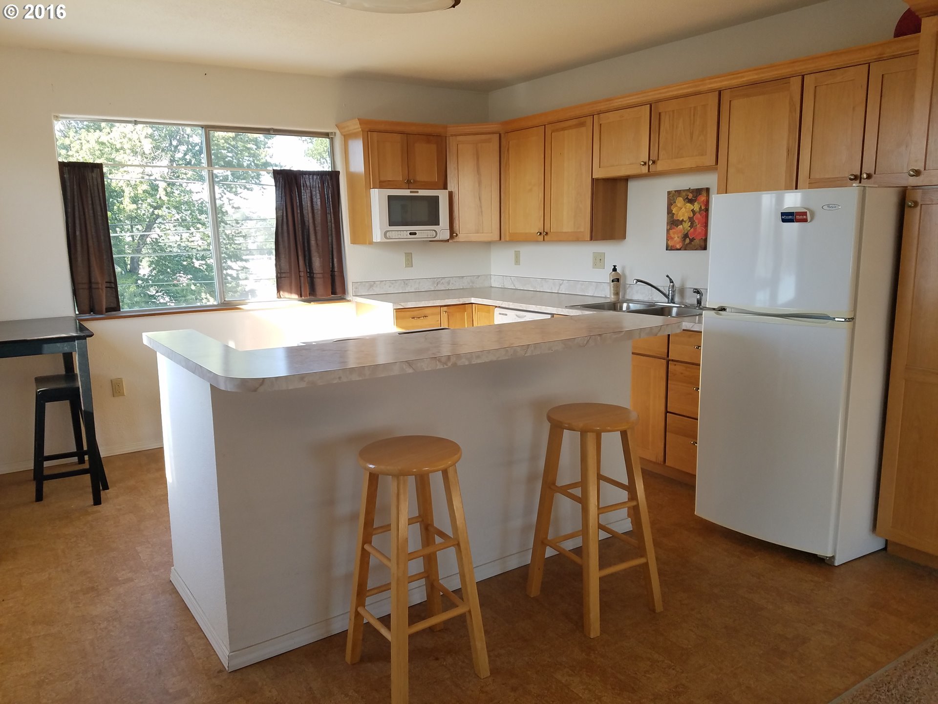 1807 Southwest Goodwin Place Pendleton, OR 97801 - Photo 19 of 24 a kitchen with a refrigerator a stove a sink and a chairs