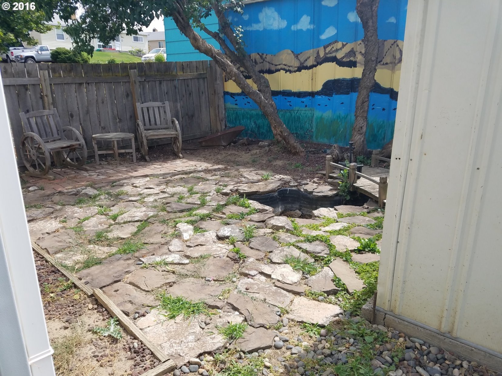 1807 Southwest Goodwin Place Pendleton, OR 97801 - Photo 2 of 24 a backyard of a house with table and chairs
