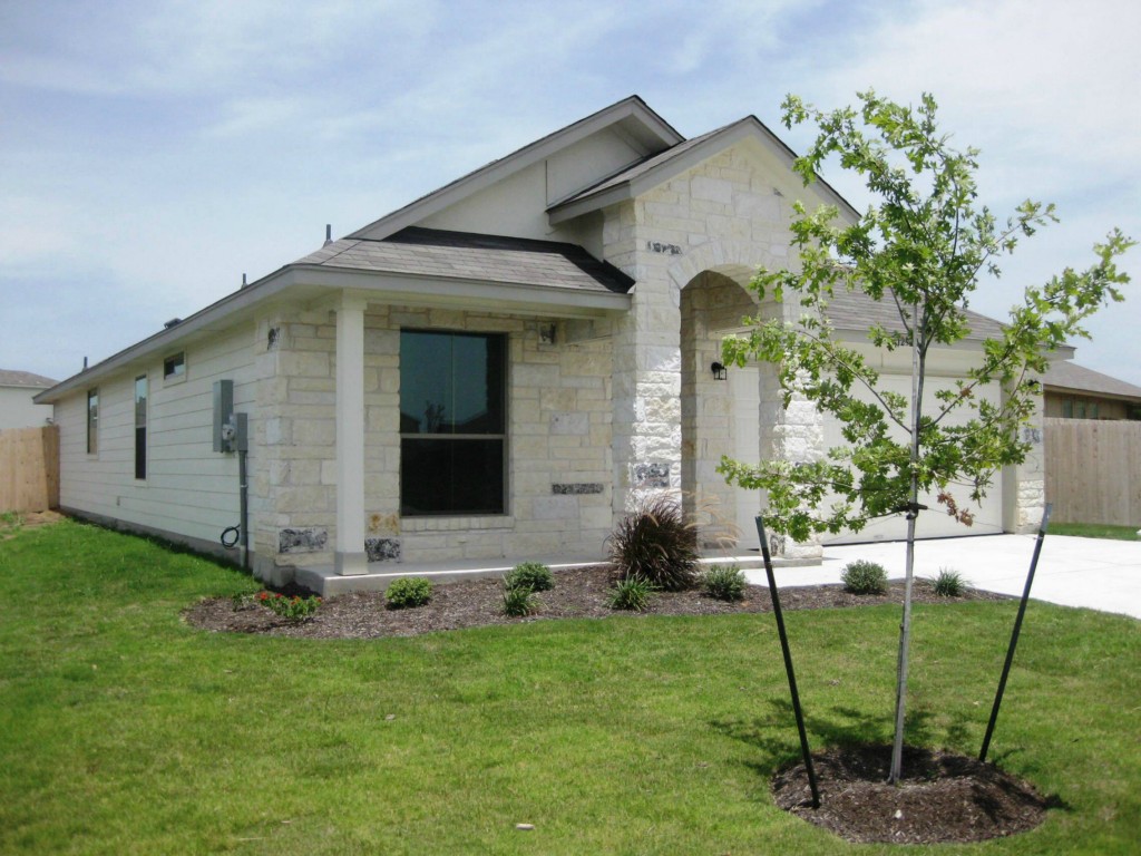 12920 Snow Lane Manor, TX 78653 - Photo 1 of 1 a front view of a house with garden