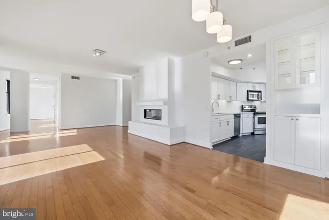 a view of a kitchen with a stove cabinets and wooden floor