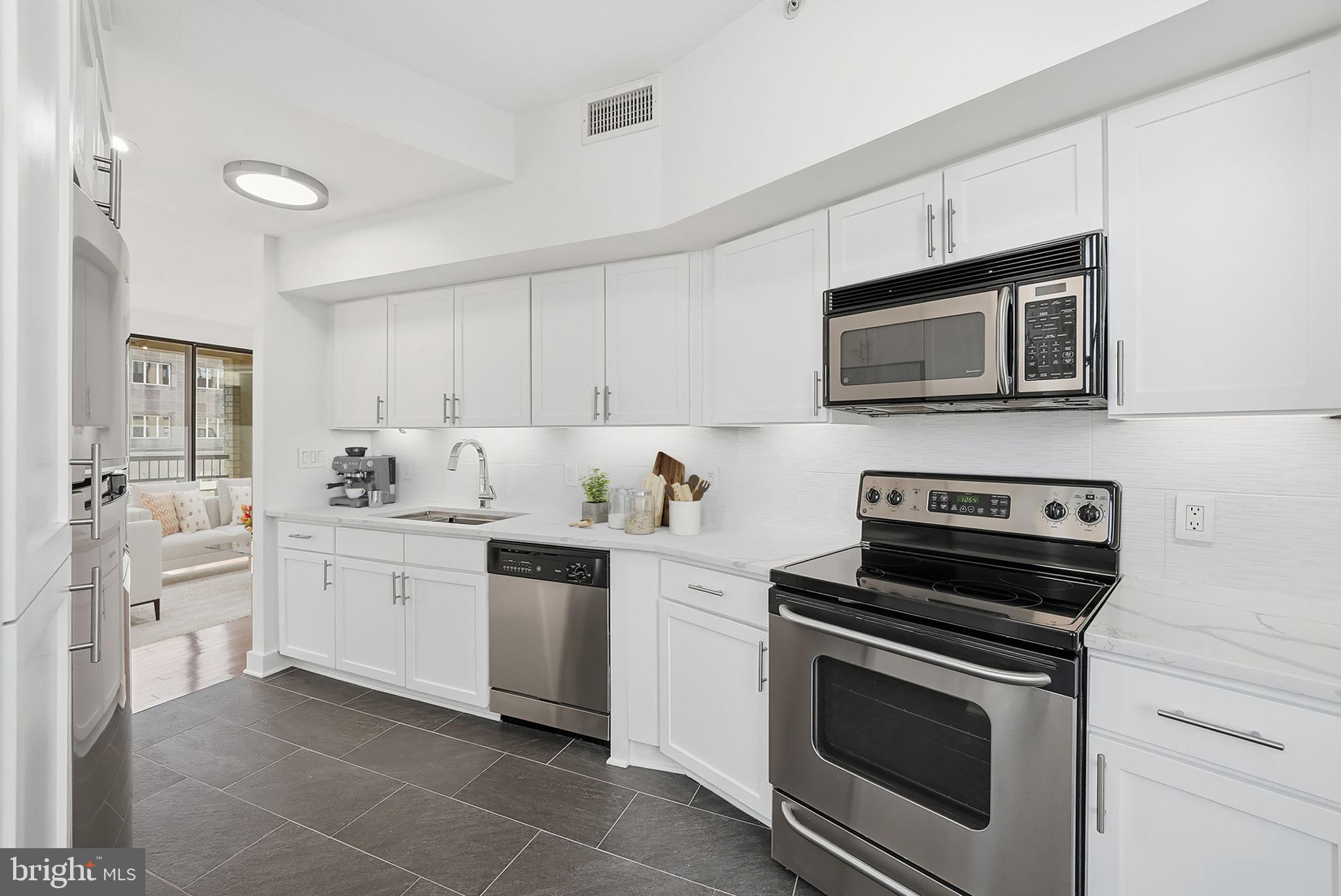 400 Massachusetts Avenue Northwest, Unit 719 Washington, DC 20001 - Photo 17 of 38 a kitchen with cabinets stainless steel appliances and sink