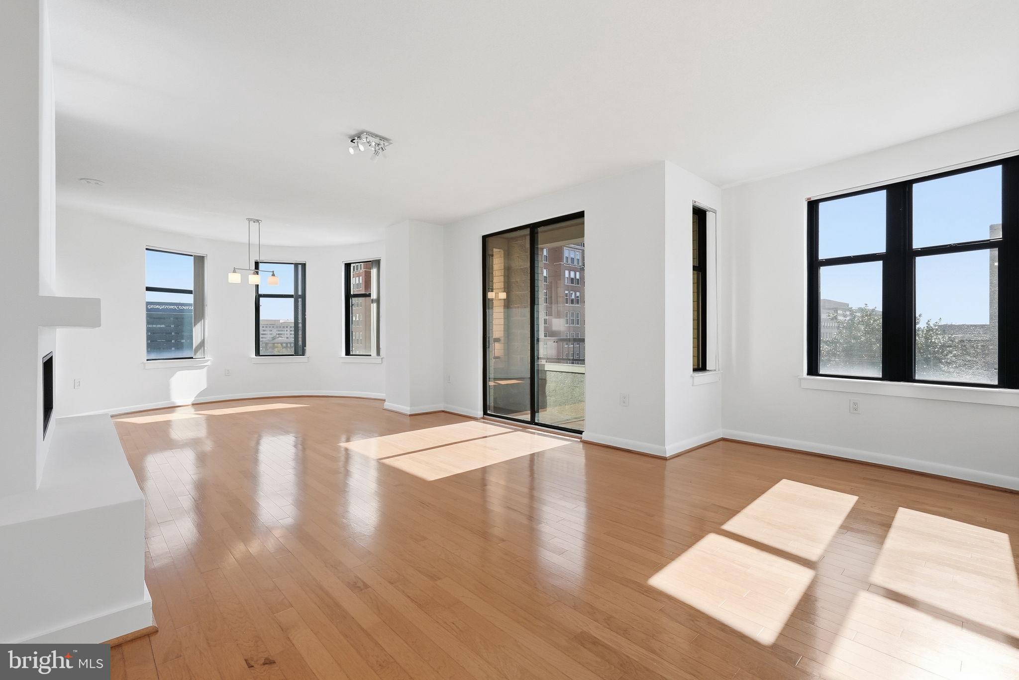 400 Massachusetts Avenue Northwest, Unit 719 Washington, DC 20001 - Photo 2 of 38 a view of an empty room with window and wooden floor