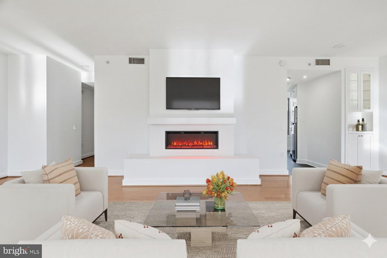400 Massachusetts Avenue Northwest, Unit 719 Washington, DC 20001 - Photo 21 of 38 a living room with furniture and a flat screen tv