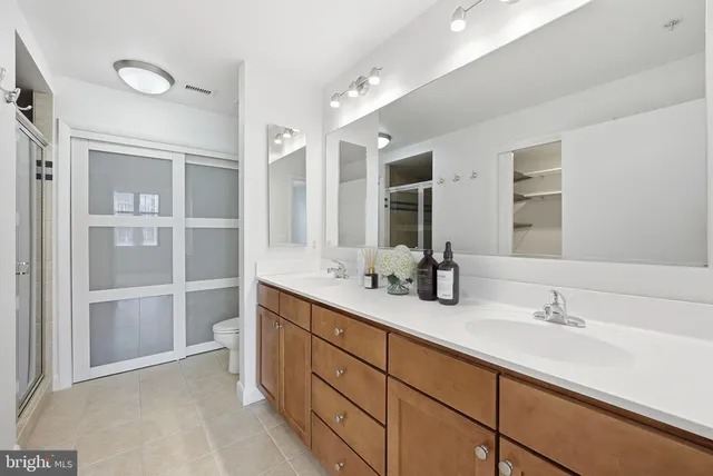 a bathroom with double vanity sinks double vanity and a shower