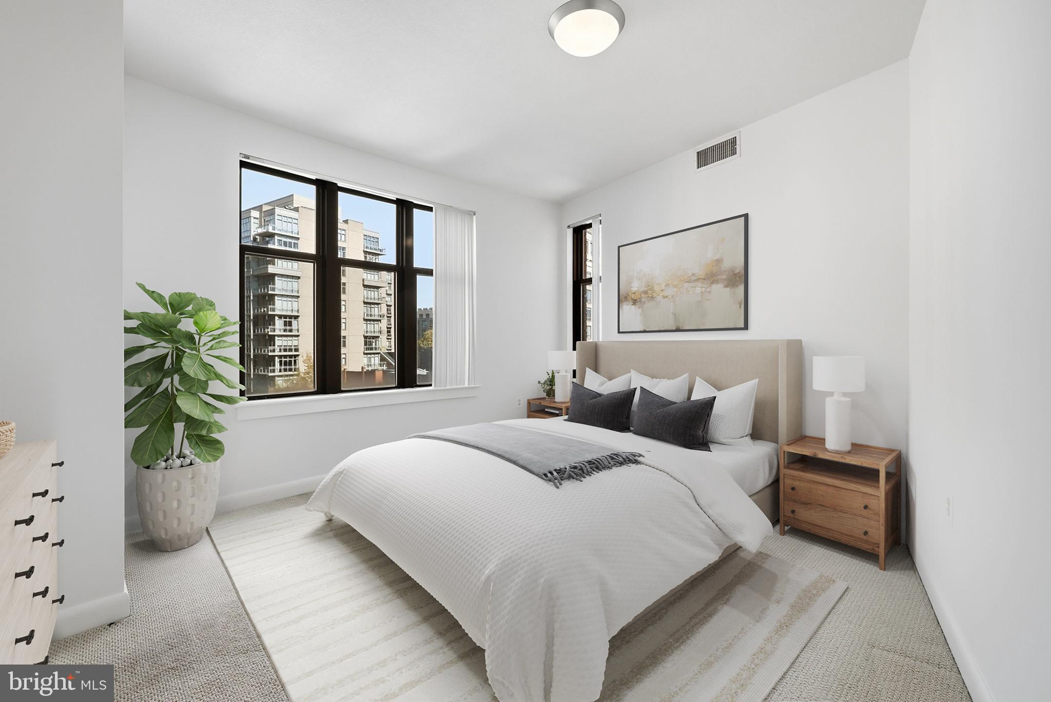 400 Massachusetts Avenue Northwest, Unit 719 Washington, DC 20001 - Photo 25 of 38 a bedroom with a large bed and a potted plant