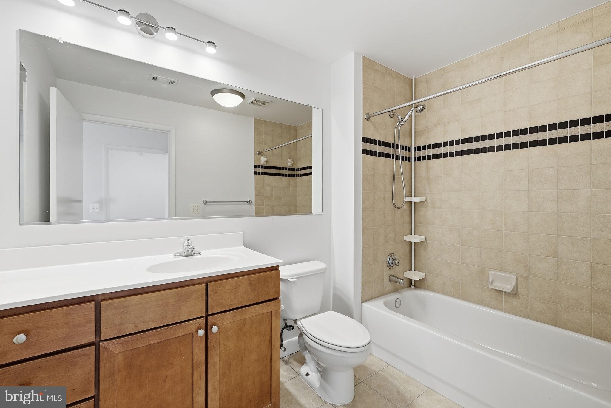 400 Massachusetts Avenue Northwest, Unit 719 Washington, DC 20001 - Photo 27 of 38 a bathroom with a sink toilet a mirror and shower