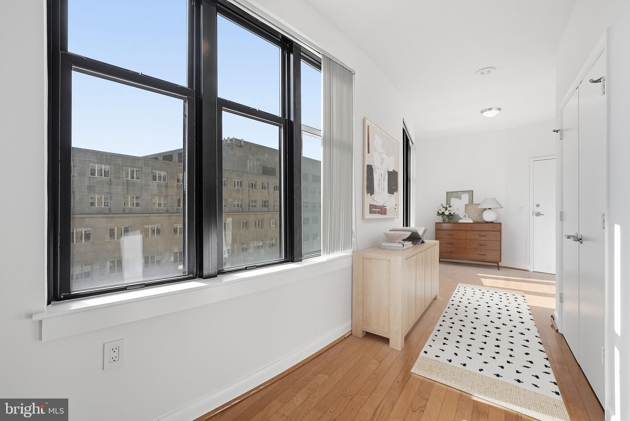 400 Massachusetts Avenue Northwest, Unit 719 Washington, DC 20001 - Photo 28 of 38 a bedroom with a bed and wooden floor