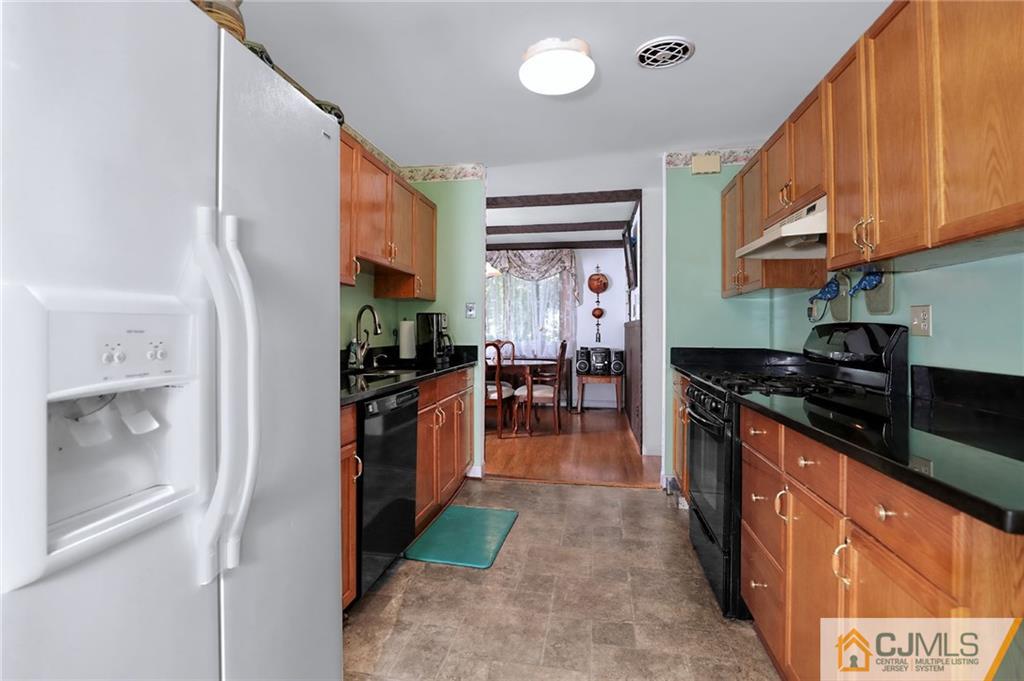 16 Joline Road Kendall Park, NJ 08824 - Photo 11 of 23 a kitchen with stainless steel appliances granite countertop a refrigerator a stove and a sink