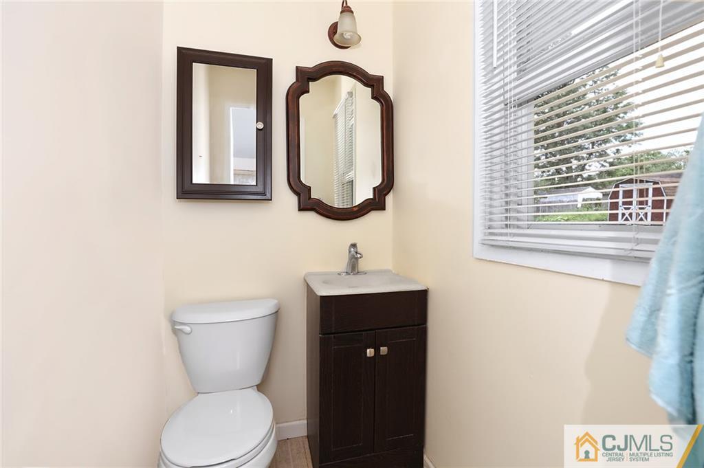 16 Joline Road Kendall Park, NJ 08824 - Photo 15 of 23 a bathroom with a toilet sink and mirror