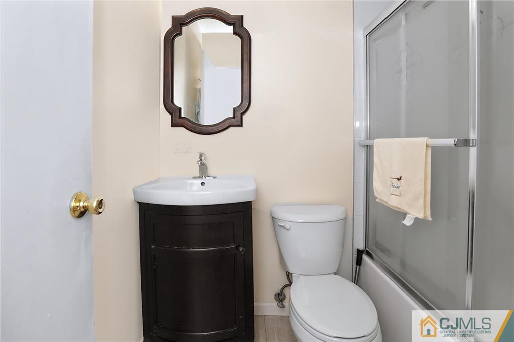 16 Joline Road Kendall Park, NJ 08824 - Photo 17 of 23 a bathroom with a toilet sink and mirror