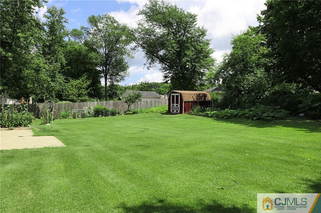 16 Joline Road Kendall Park, NJ 08824 - Photo 21 of 23 a backyard of a house with plants and large trees