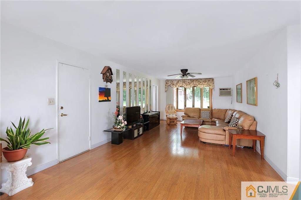 16 Joline Road Kendall Park, NJ 08824 - Photo 4 of 23 a living room with furniture and wooden floor