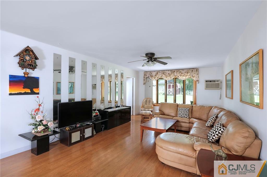 16 Joline Road Kendall Park, NJ 08824 - Photo 6 of 23 a living room with furniture and a flat screen tv