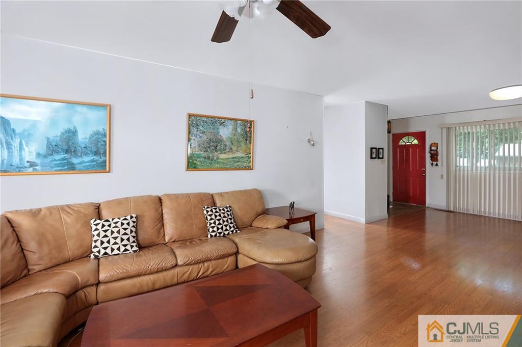 16 Joline Road Kendall Park, NJ 08824 - Photo 8 of 23 a living room with furniture and a ceiling fan