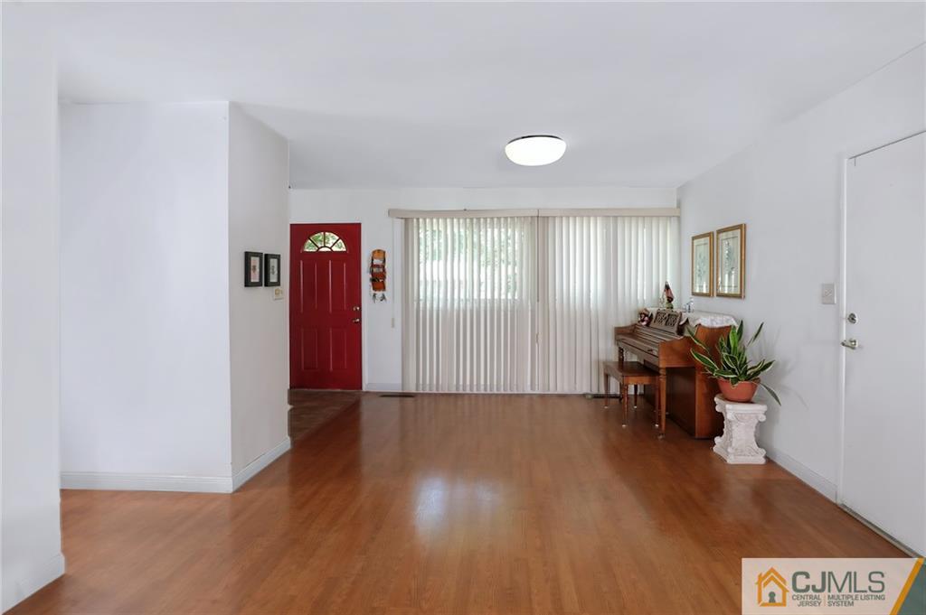 16 Joline Road Kendall Park, NJ 08824 - Photo 9 of 23 a view of a livingroom with furniture and a window