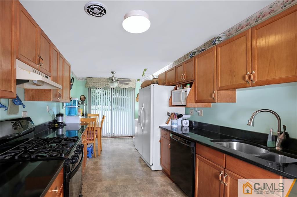 16 Joline Road Kendall Park, NJ 08824 - Photo 10 of 23 a kitchen with granite countertop a stove and a sink