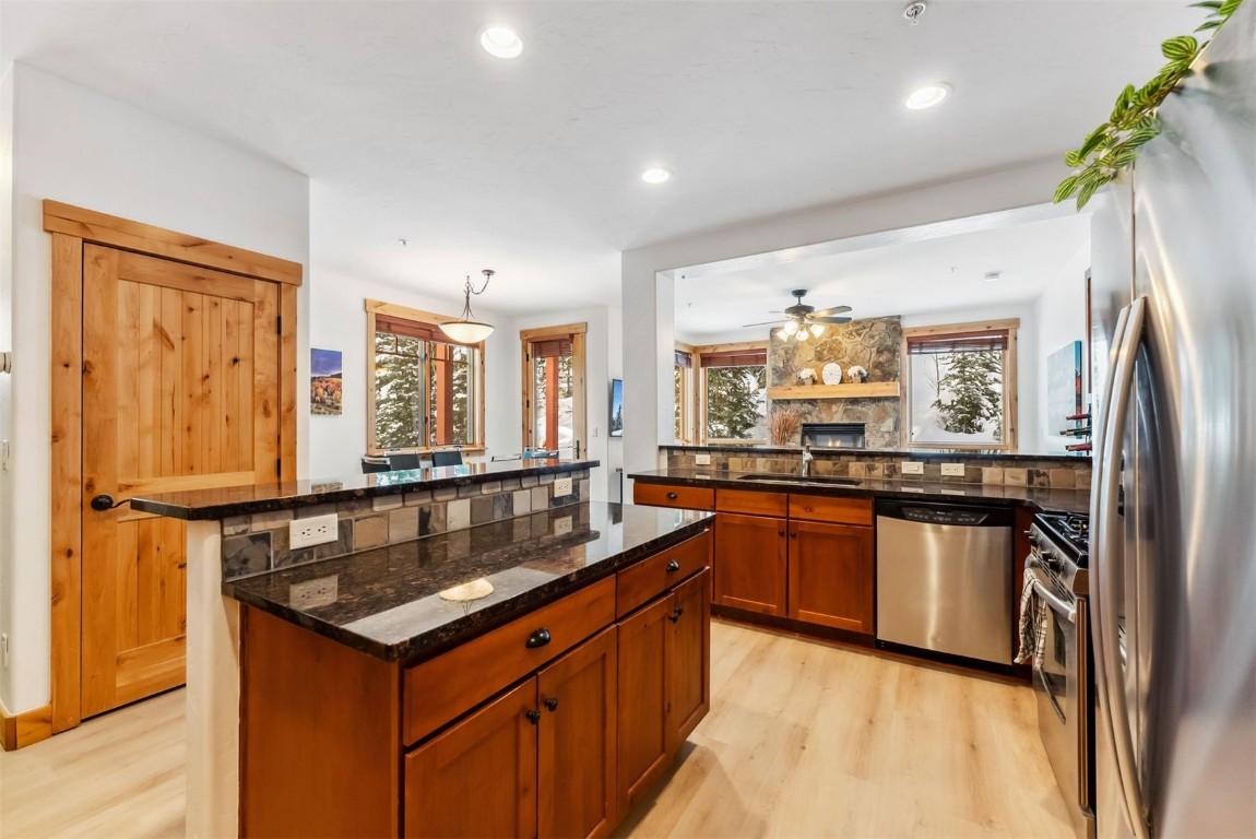 35 Tip Top Trail, Unit 6500 Keystone, CO 80435 - Photo 11 of 47 a kitchen with stainless steel appliances granite countertop a sink a stove and a refrigerator