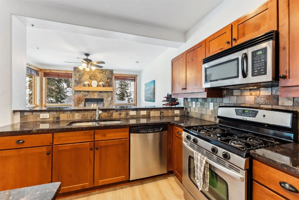 35 Tip Top Trail, Unit 6500 Keystone, CO 80435 - Photo 12 of 47 a kitchen with stainless steel appliances granite countertop a stove a sink and a microwave