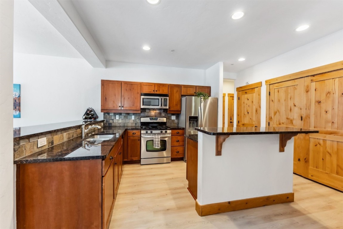 35 Tip Top Trail, Unit 6500 Keystone, CO 80435 - Photo 13 of 47 a kitchen with stainless steel appliances granite countertop a refrigerator a stove top oven a sink and dishwasher
