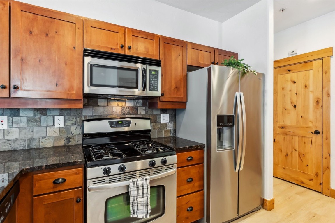 35 Tip Top Trail, Unit 6500 Keystone, CO 80435 - Photo 14 of 47 a kitchen with stainless steel appliances granite countertop a refrigerator stove and microwave