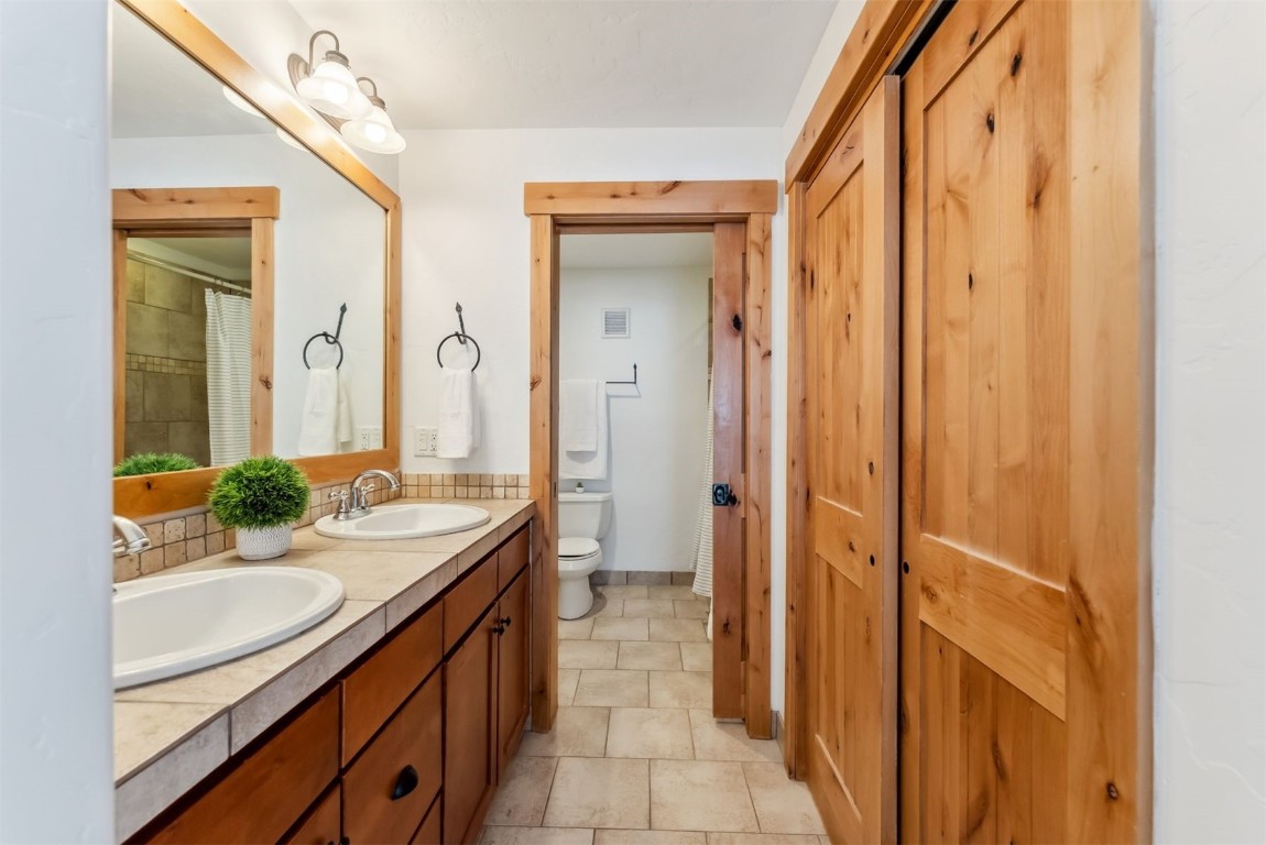 35 Tip Top Trail, Unit 6500 Keystone, CO 80435 - Photo 19 of 47 a bathroom with a double vanity sink and a mirror