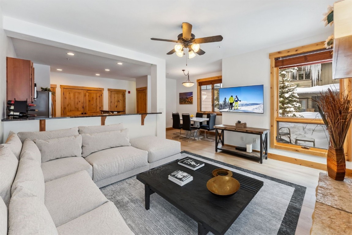 35 Tip Top Trail, Unit 6500 Keystone, CO 80435 - Photo 3 of 47 a living room with furniture and a dining table with kitchen view