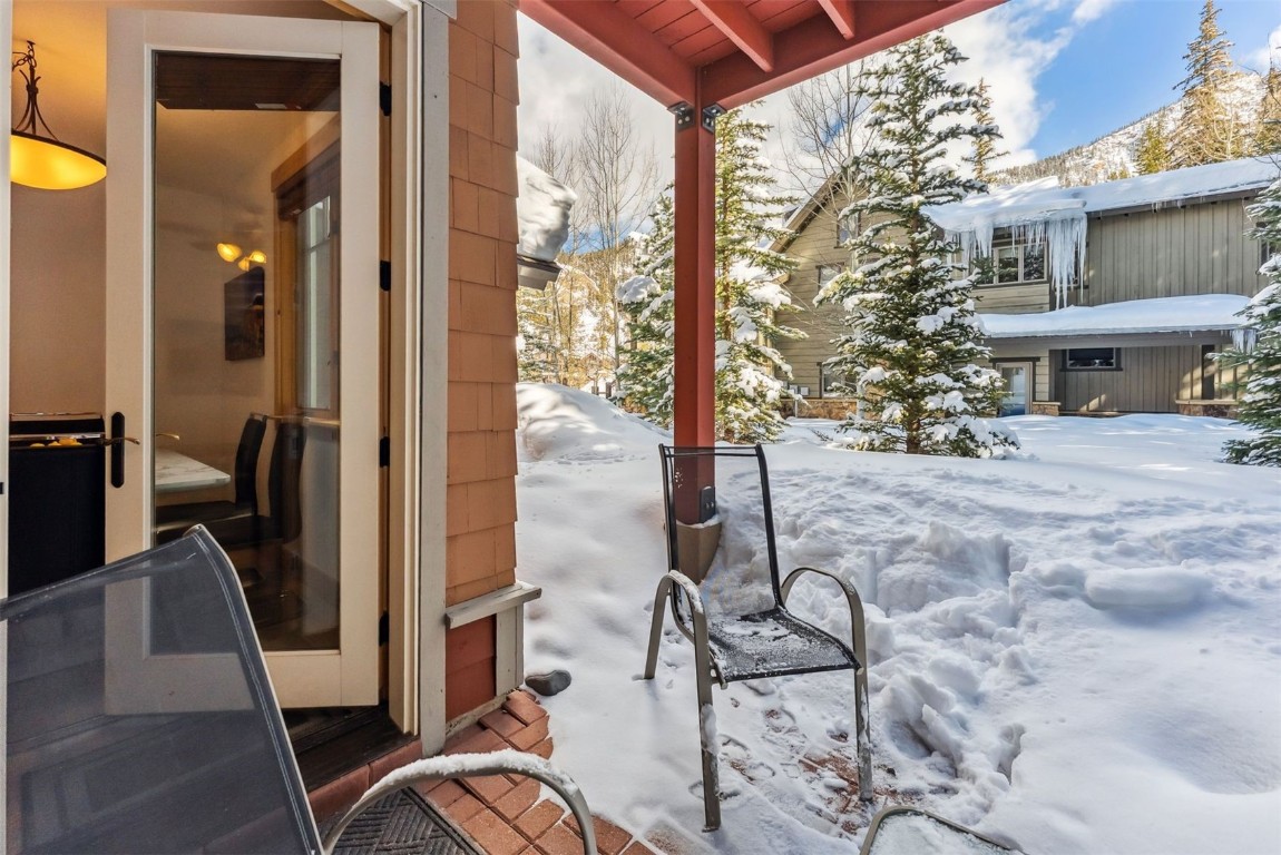 35 Tip Top Trail, Unit 6500 Keystone, CO 80435 - Photo 34 of 47 a view of a porch with chairs and backyard