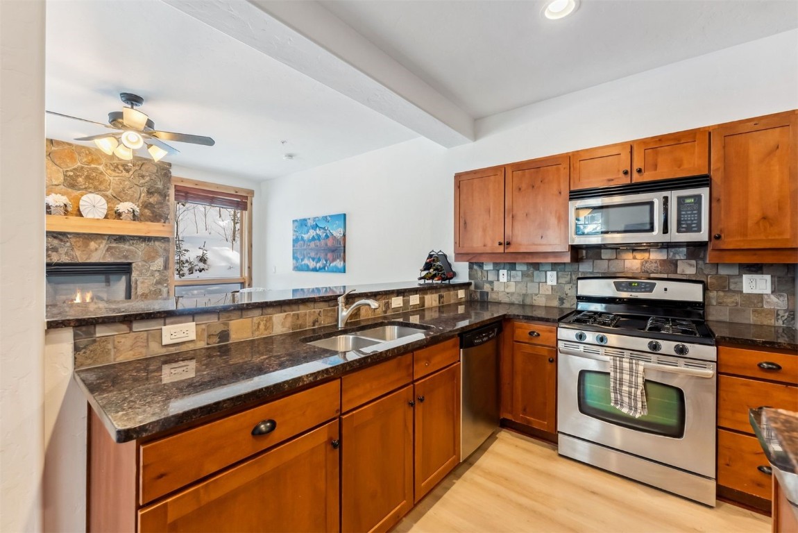 35 Tip Top Trail, Unit 6500 Keystone, CO 80435 - Photo 5 of 47 a kitchen with stainless steel appliances granite countertop a stove a sink and a microwave