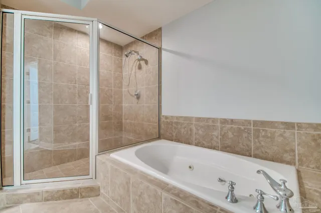 a bathroom with a tub and shower