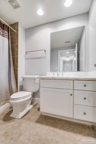 a bathroom with a toilet sink and a mirror