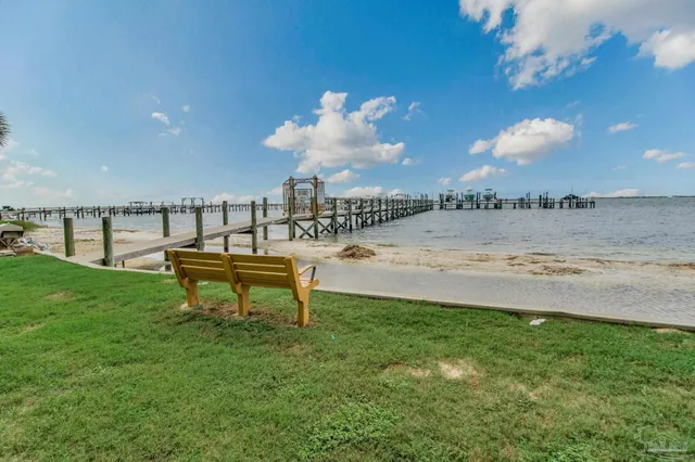a view of a swimming pool with a yard and a fountain