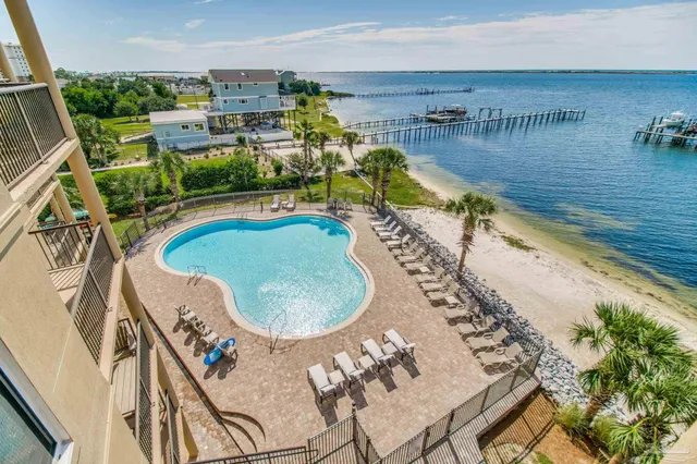 a view of a swimming pool with a yard and sitting area