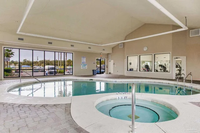 a large white kitchen with a large window