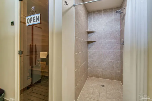 a bathroom with a shower and a sink