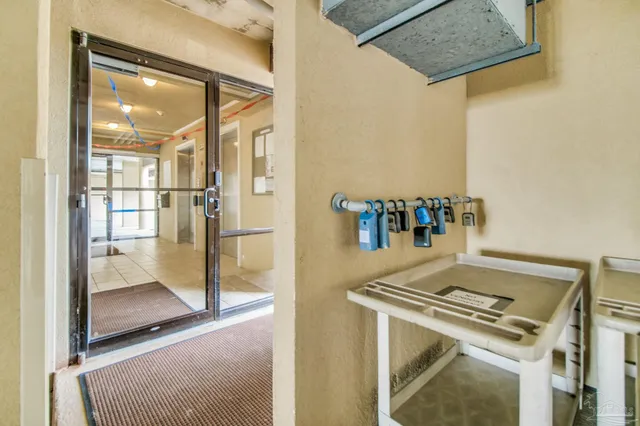 a kitchen with a stove and a view of living area