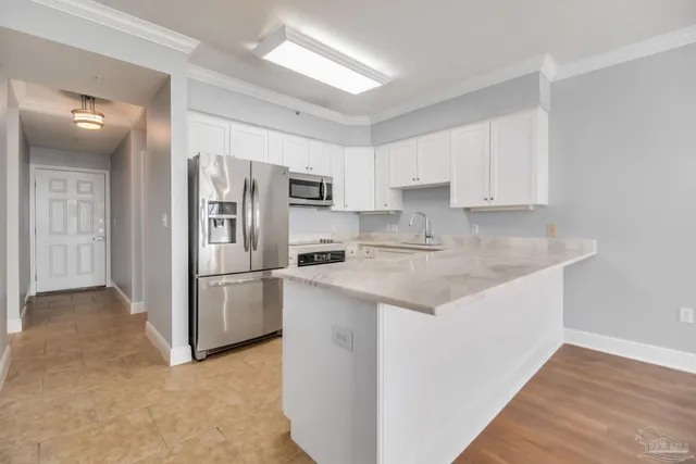 a kitchen with stainless steel appliances granite countertop a refrigerator and a stove