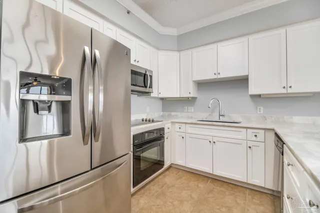 a kitchen with stainless steel appliances and refrigerator