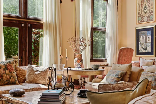 a view of a dining room with furniture and chandelier