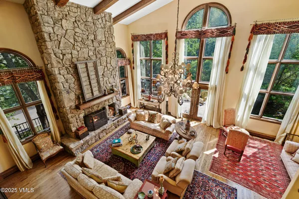 a spacious bedroom with a bed and wooden floor