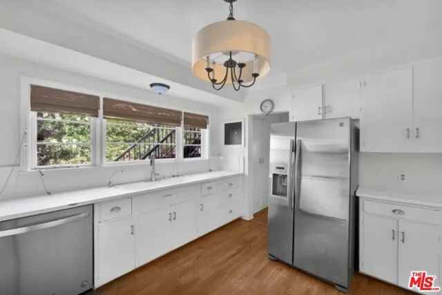 a kitchen with a refrigerator and a sink