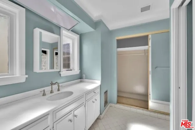 a spacious bathroom with a shower and a sink
