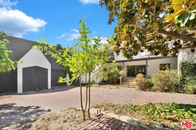 a front view of a house with a yard and a garage
