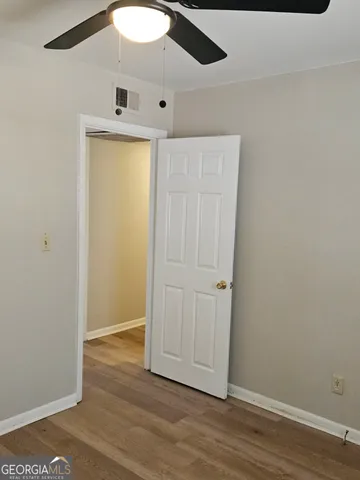 an empty room with wooden floor