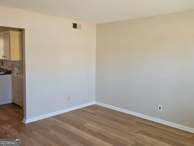 a view of a room with wooden floor