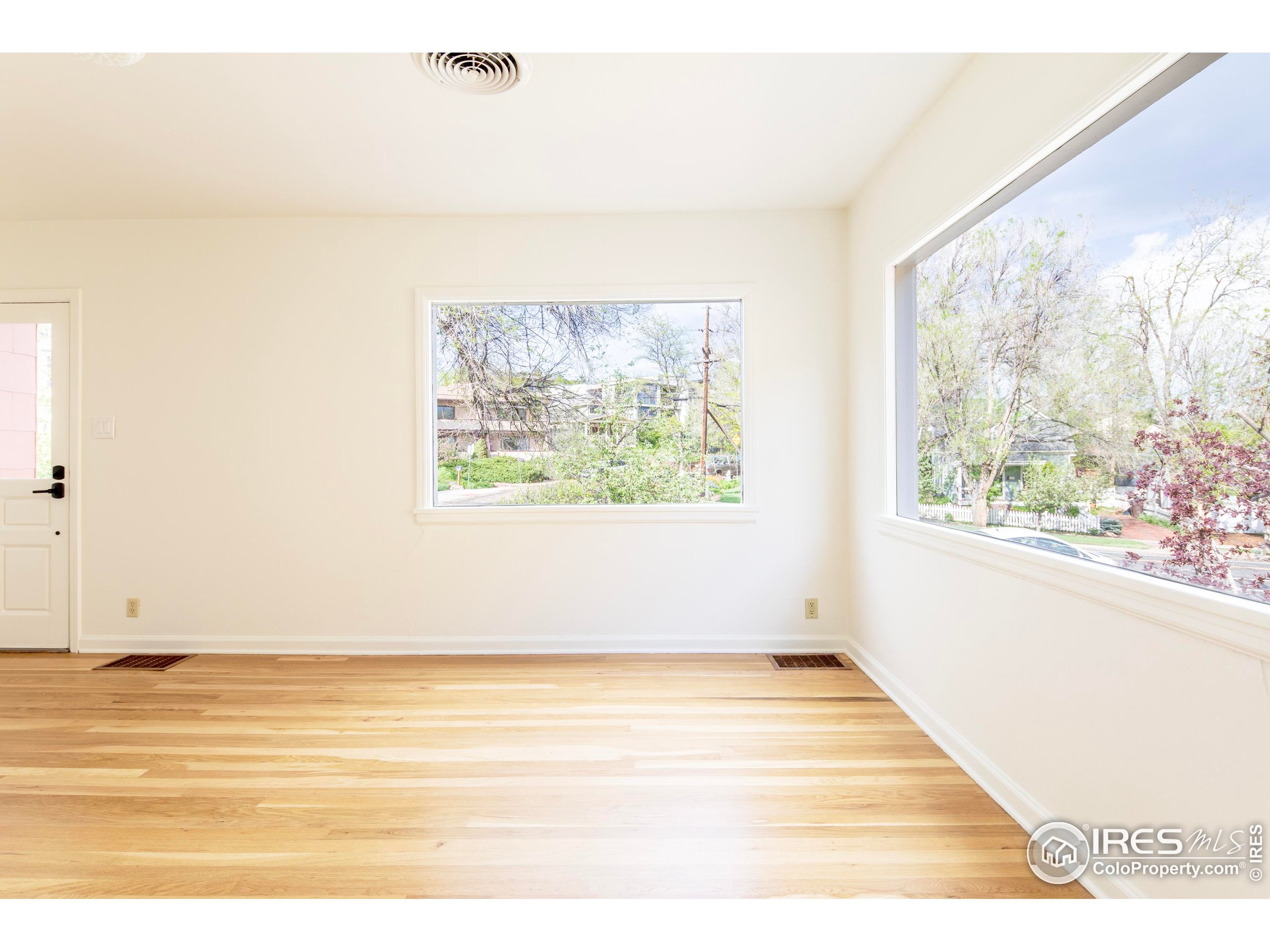 2447 20th Street Boulder, CO 80304 - Photo 13 of 35 a view of an empty room with wooden floor and a window