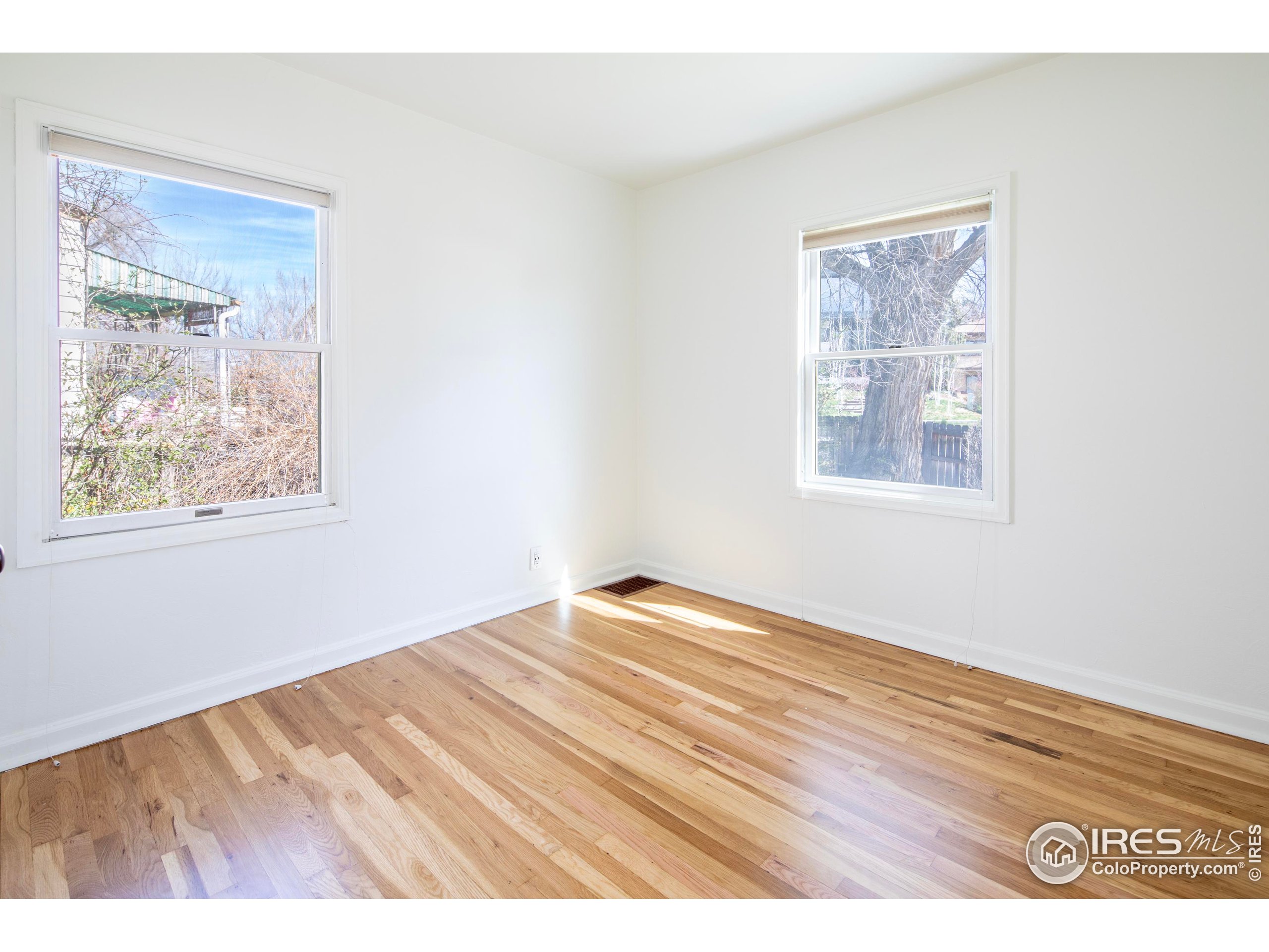 2447 20th Street Boulder, CO 80304 - Photo 14 of 35 a view of an empty room with wooden floor and a window