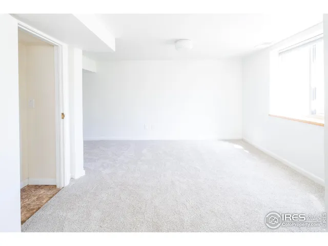 a backyard of a house with a yard and large tree