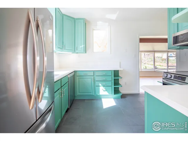 a kitchen with window and refrigerator
